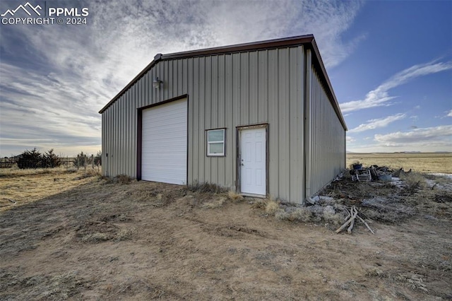 garage featuring a rural view