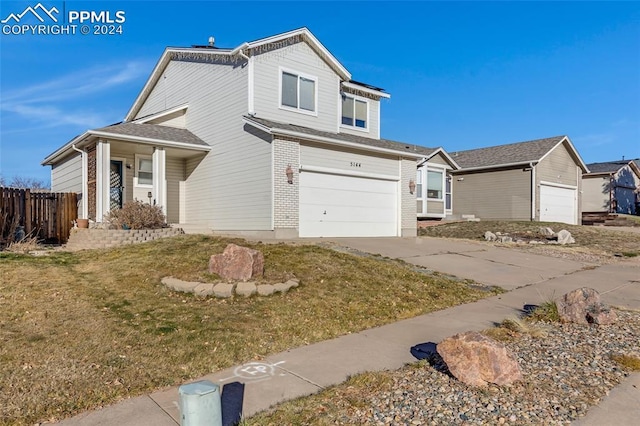 front facade with a garage and a front yard