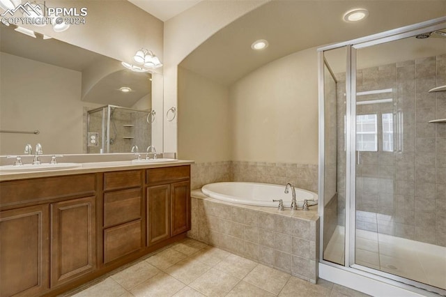 bathroom with tile patterned flooring, vanity, and shower with separate bathtub