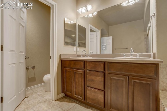 bathroom featuring tile patterned floors, vanity, and toilet