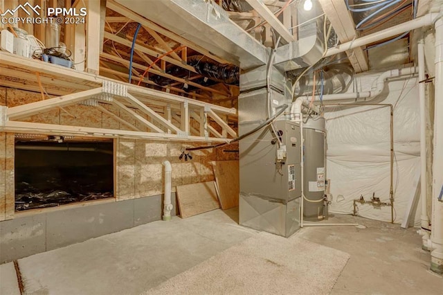 utility room with heating unit and water heater