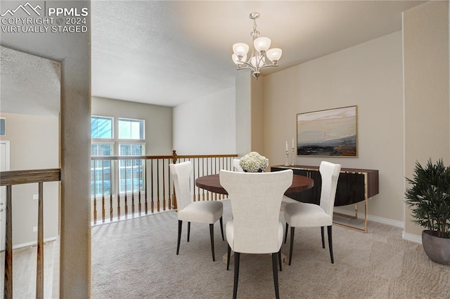 dining area featuring a textured ceiling, light carpet, and an inviting chandelier