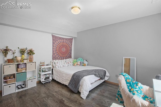 bedroom with dark wood-type flooring