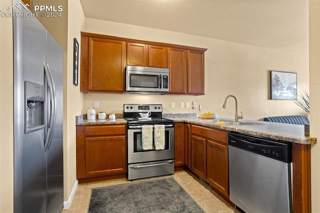 kitchen featuring sink, light tile patterned flooring, and appliances with stainless steel finishes