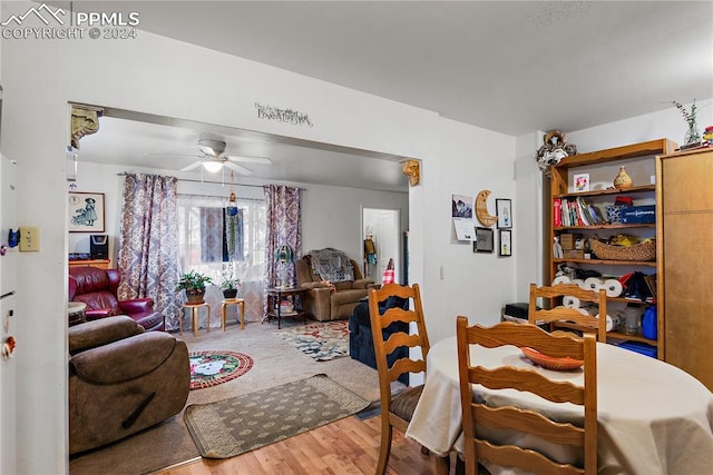 dining area with wood-type flooring and ceiling fan