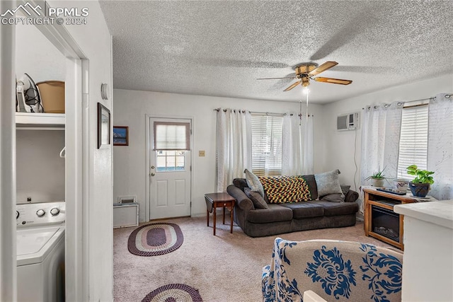 carpeted living room with washer / clothes dryer, ceiling fan, a wall mounted air conditioner, and a textured ceiling