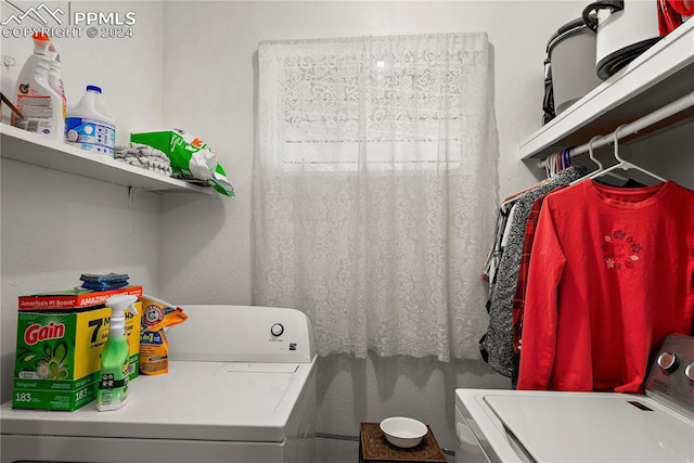 clothes washing area featuring washing machine and clothes dryer