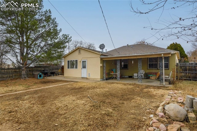 rear view of property featuring a patio area