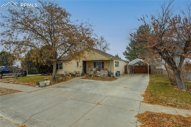 view of front of property featuring a carport and covered porch