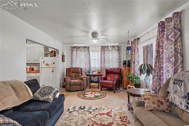 living room with ceiling fan and light colored carpet