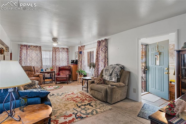 carpeted living room featuring ceiling fan