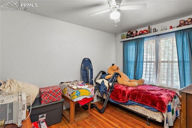 bedroom featuring hardwood / wood-style floors and ceiling fan