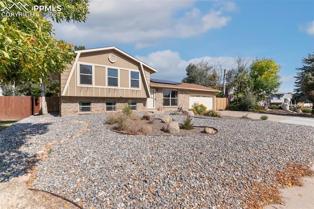 view of front of house with solar panels and a garage