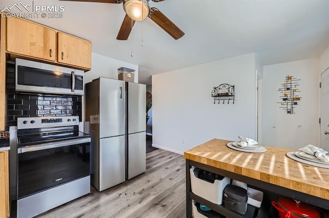 kitchen featuring appliances with stainless steel finishes, decorative backsplash, ceiling fan, light brown cabinets, and light wood-type flooring