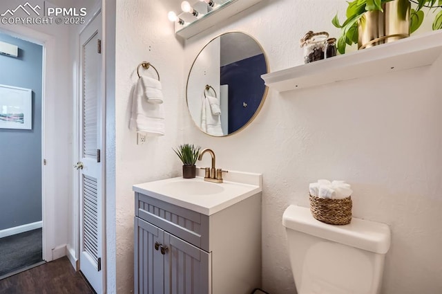 bathroom with vanity, hardwood / wood-style floors, and toilet