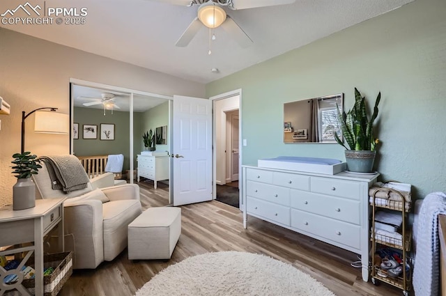 sitting room with hardwood / wood-style floors and ceiling fan