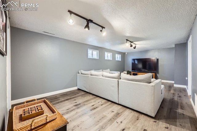 living room with wood-type flooring and a textured ceiling