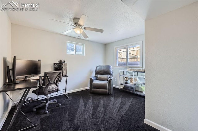 office space featuring ceiling fan, dark carpet, and a textured ceiling