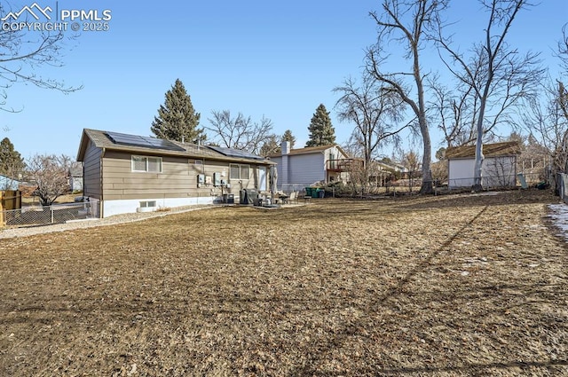 rear view of property with solar panels