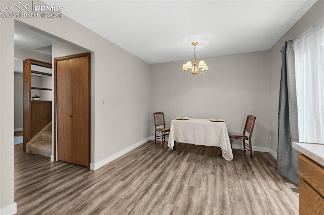 dining space featuring light hardwood / wood-style floors and a notable chandelier