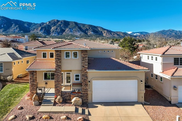 mediterranean / spanish house featuring a mountain view and a garage