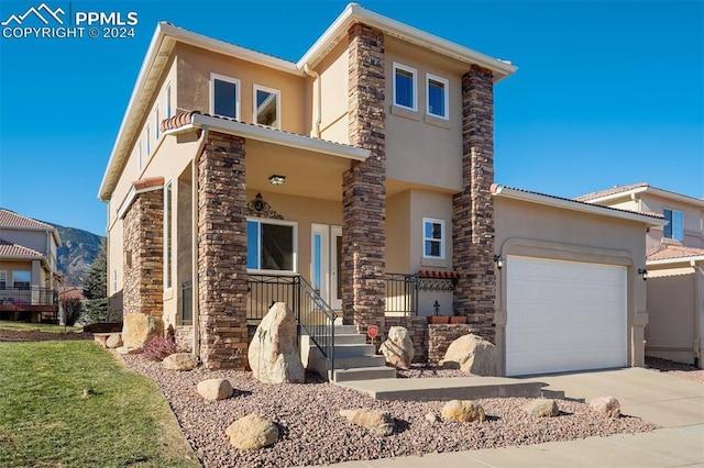 view of front of home featuring a porch and a garage