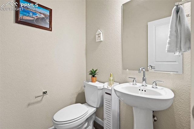 bathroom with toilet and sink