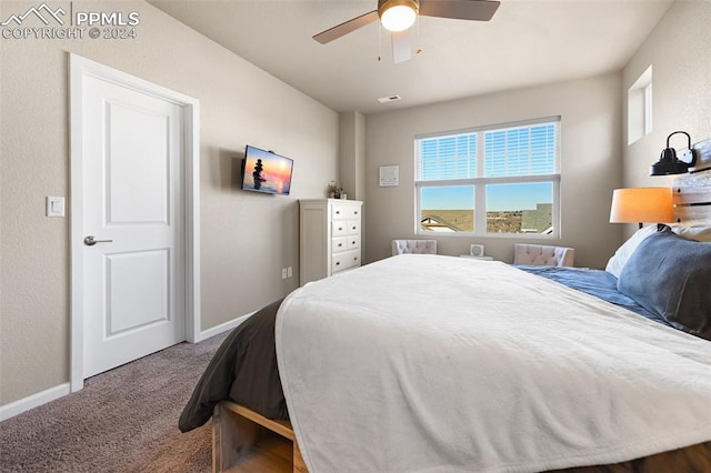 bedroom featuring ceiling fan and carpet