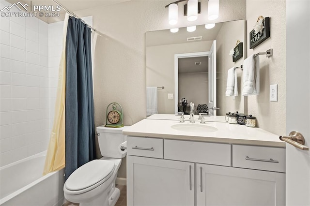 full bathroom featuring vanity, shower / bath combo, and toilet