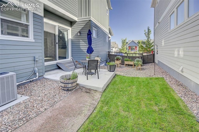 view of yard with a patio area and central air condition unit