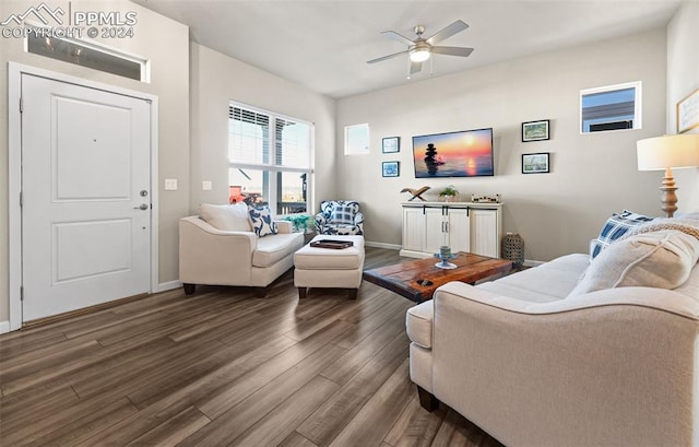 living room featuring ceiling fan and dark wood-type flooring