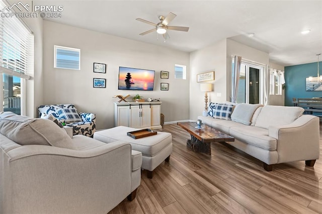 living room with light wood-type flooring and ceiling fan