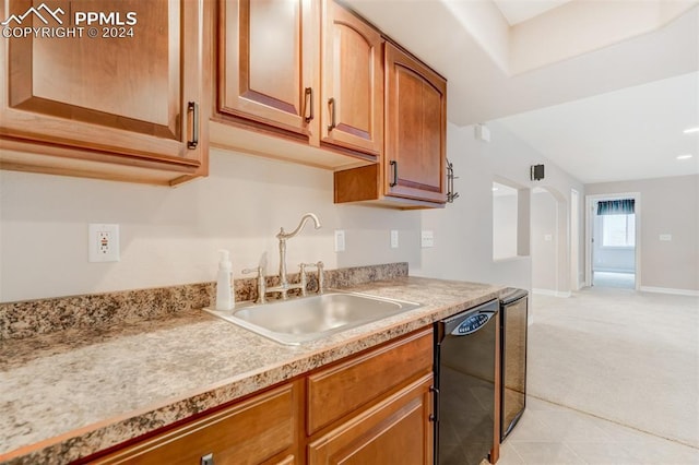 kitchen featuring black dishwasher, light colored carpet, and sink