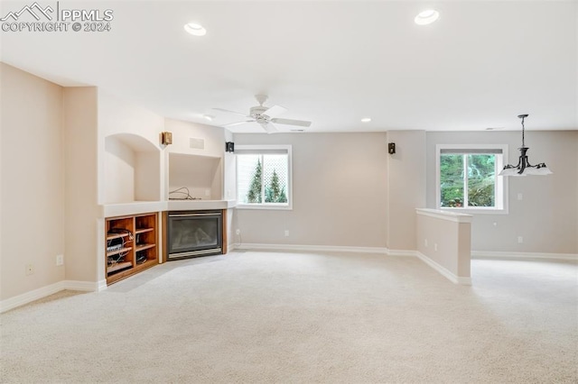 unfurnished living room featuring plenty of natural light and light colored carpet