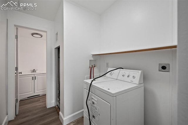 laundry room with dark wood-type flooring and washer / dryer