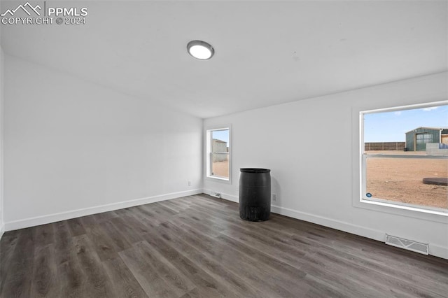 unfurnished living room with dark hardwood / wood-style flooring