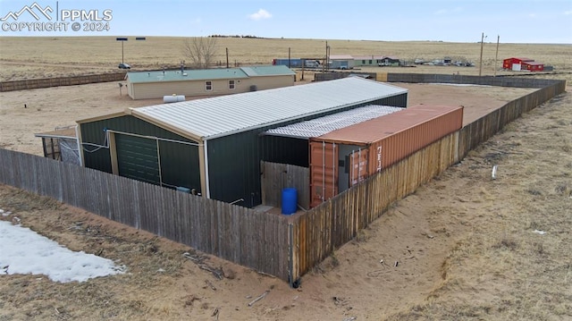 exterior space with a rural view and an outdoor structure