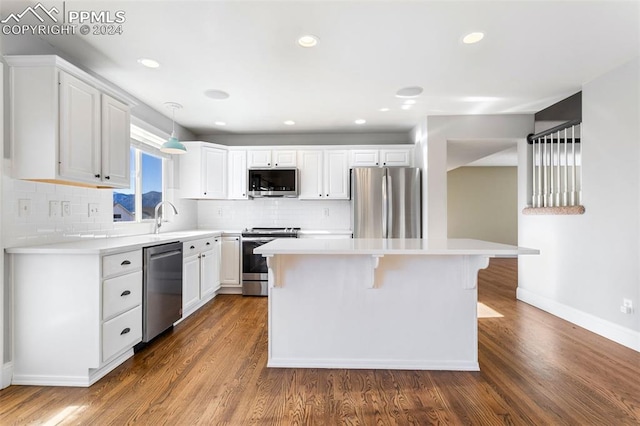 kitchen featuring appliances with stainless steel finishes, white cabinetry, and dark wood-type flooring