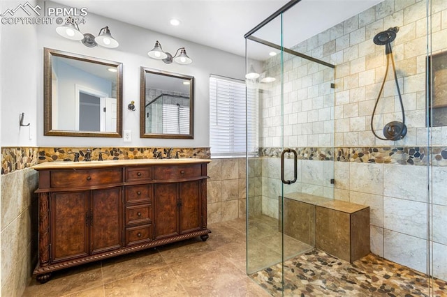 bathroom featuring vanity, tile walls, and a shower with shower door