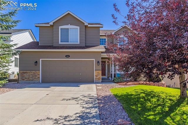 view of front of house with a garage and a front yard