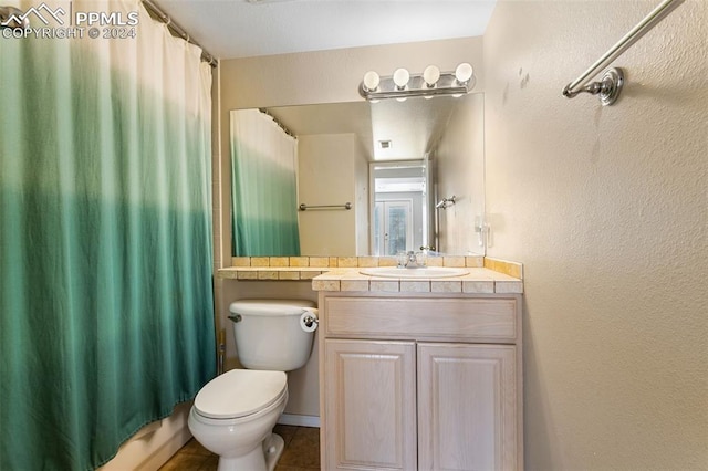 full bathroom with tile patterned flooring, shower / tub combo with curtain, vanity, and toilet