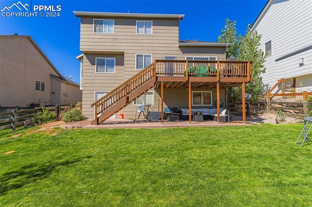 rear view of house with outdoor lounge area, a yard, a patio area, and a wooden deck