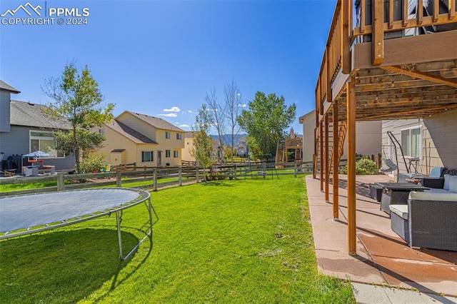 view of yard with a patio area and a trampoline