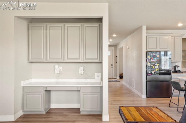 kitchen featuring black refrigerator and light wood-type flooring