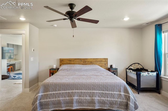 carpeted bedroom with ceiling fan