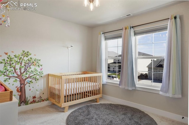 bedroom with carpet floors and a nursery area