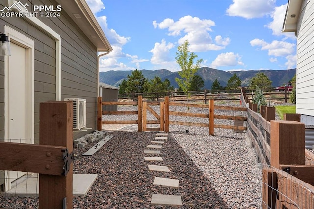 view of yard with a mountain view and ac unit