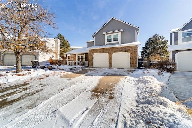 view of front property featuring covered porch and a garage