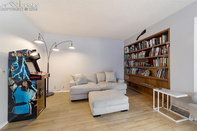 sitting room featuring a textured ceiling and light hardwood / wood-style flooring