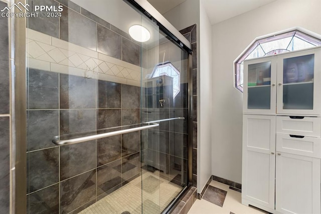 bathroom with tile patterned flooring and walk in shower